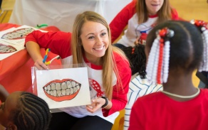 A student smiles during an outreach event.